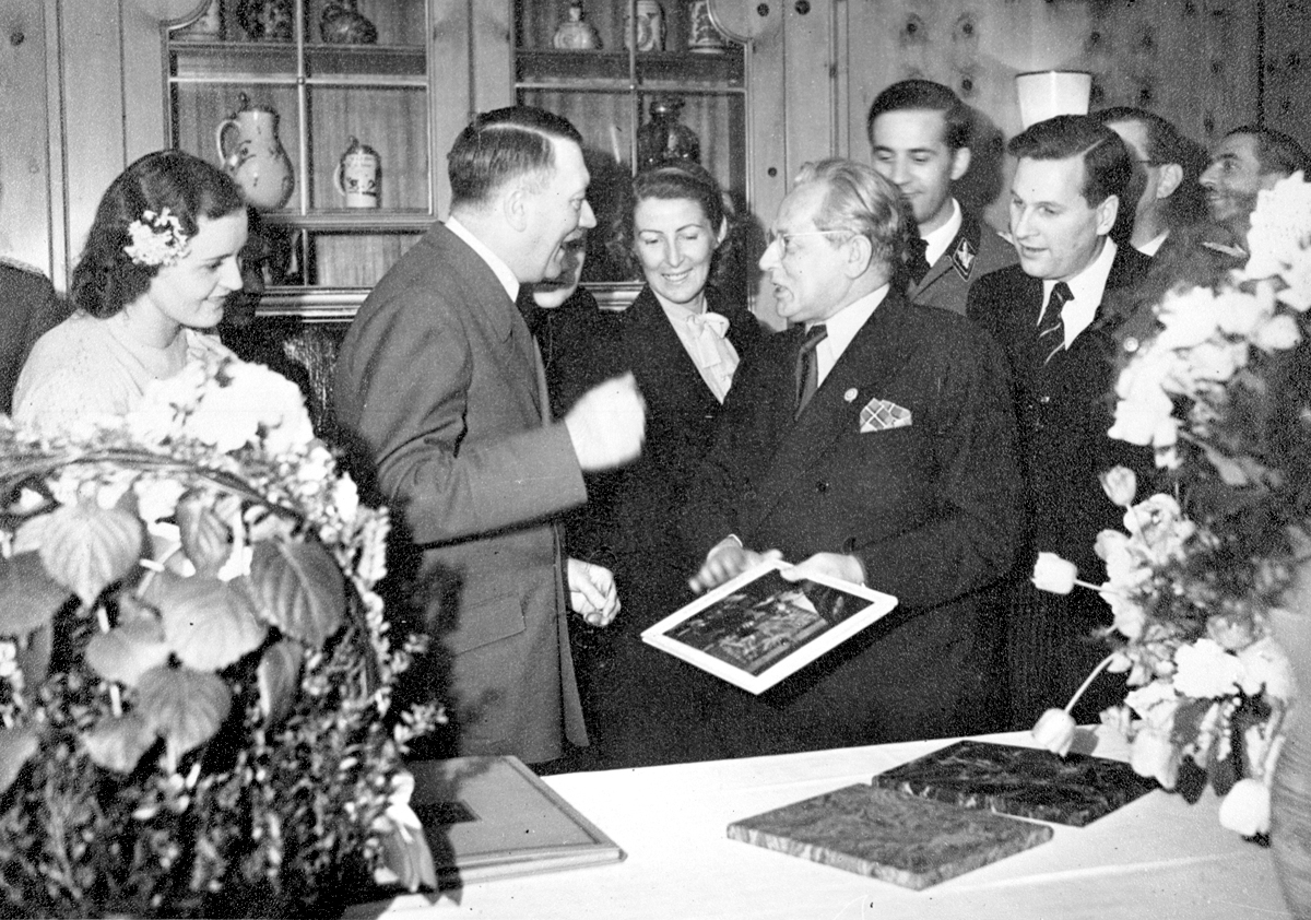 Adolf Hitler in conversation with his photographer Heinrich Hoffmann during the 54th birthday celebration of the Führer, from Eva Braun's albums